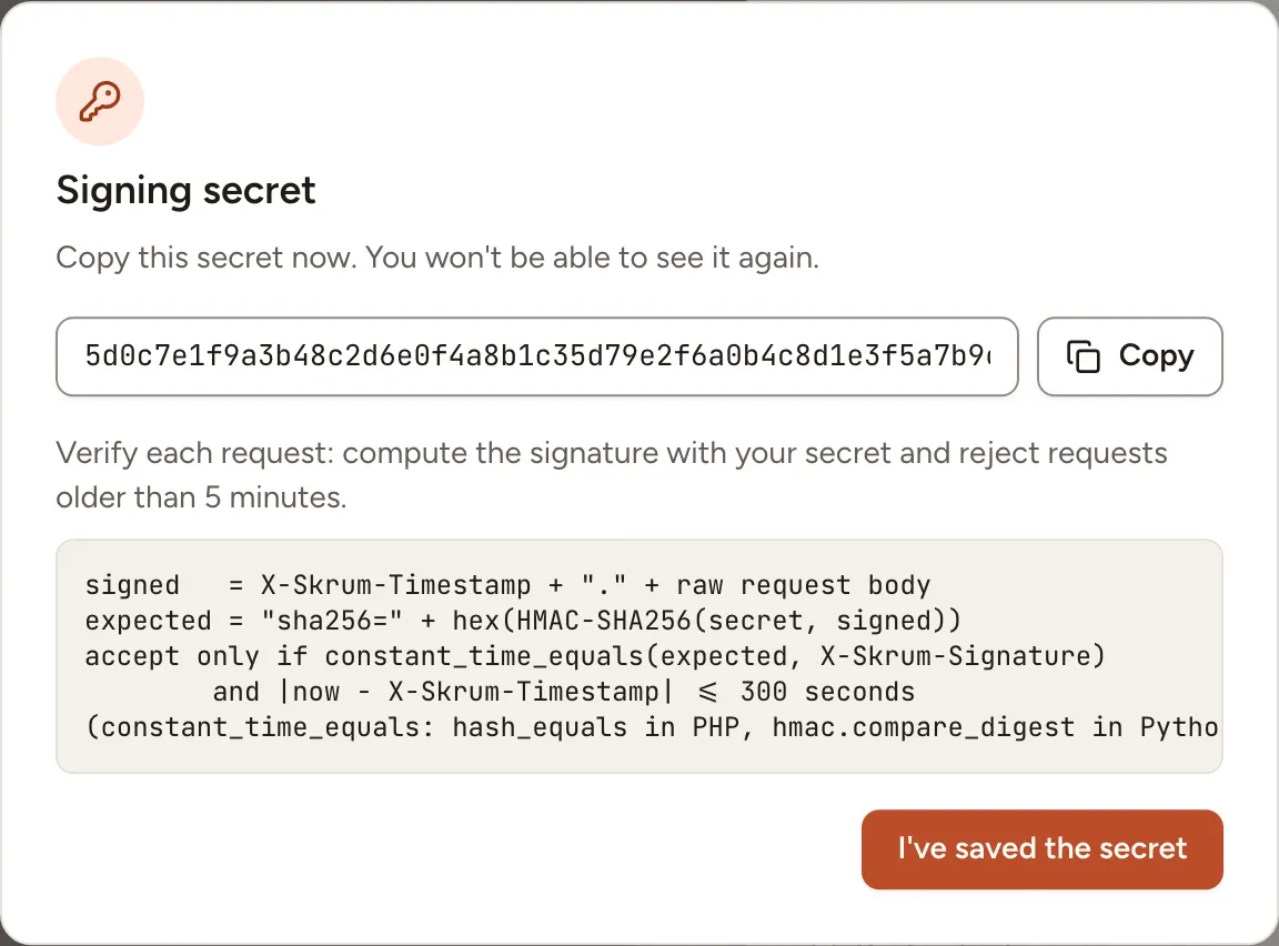 The Signing secret dialog, shown once: the secret with its Copy button and the rule to verify each request